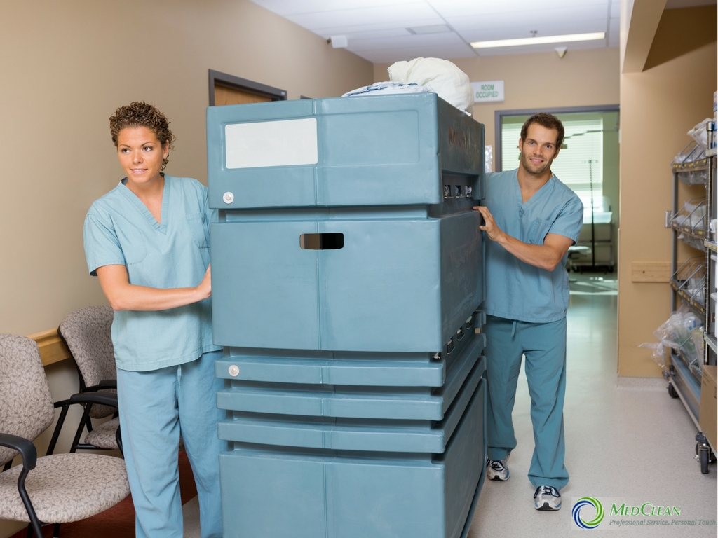 healthcare professionals with medical linen cart